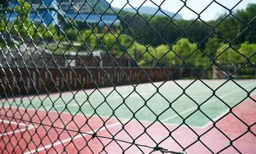 a pickleball court behind a fence