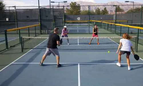 a group of people playing pickleball