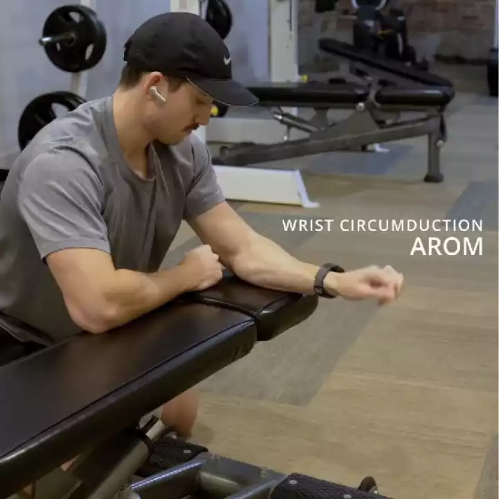 a person in a gym doing Wrist Circumduction AROM
 
